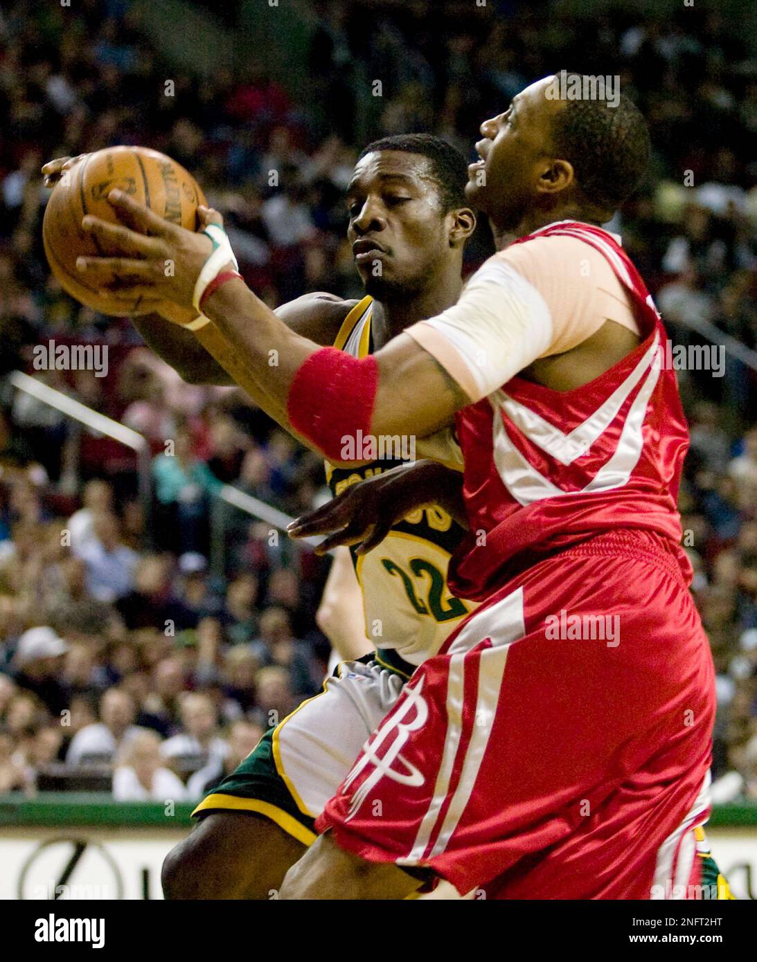 Houston Rockets' Tracy McGrady, right, tries to maintain control