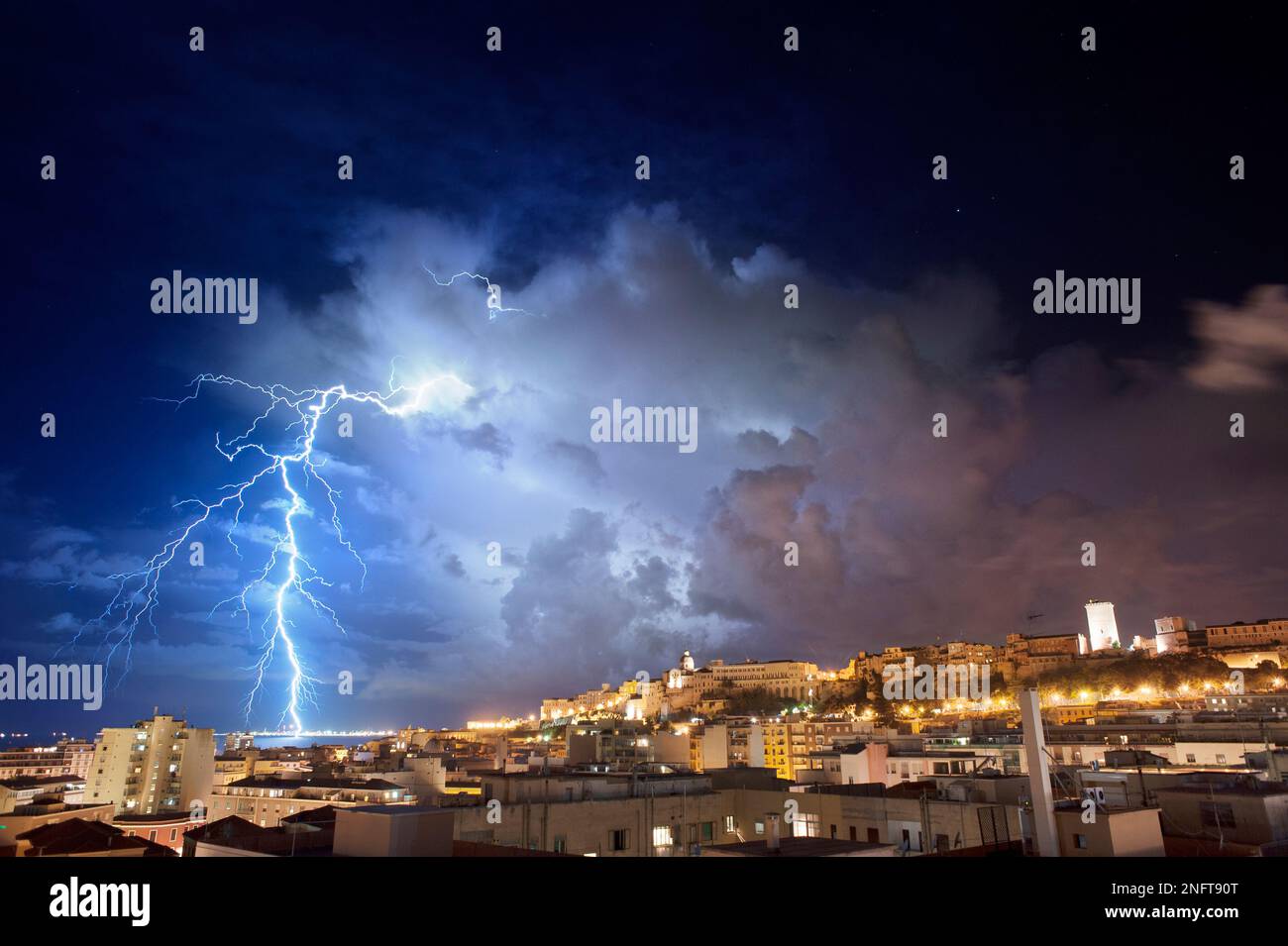Cagliari panorama at night with lightning strikes behind the city ...