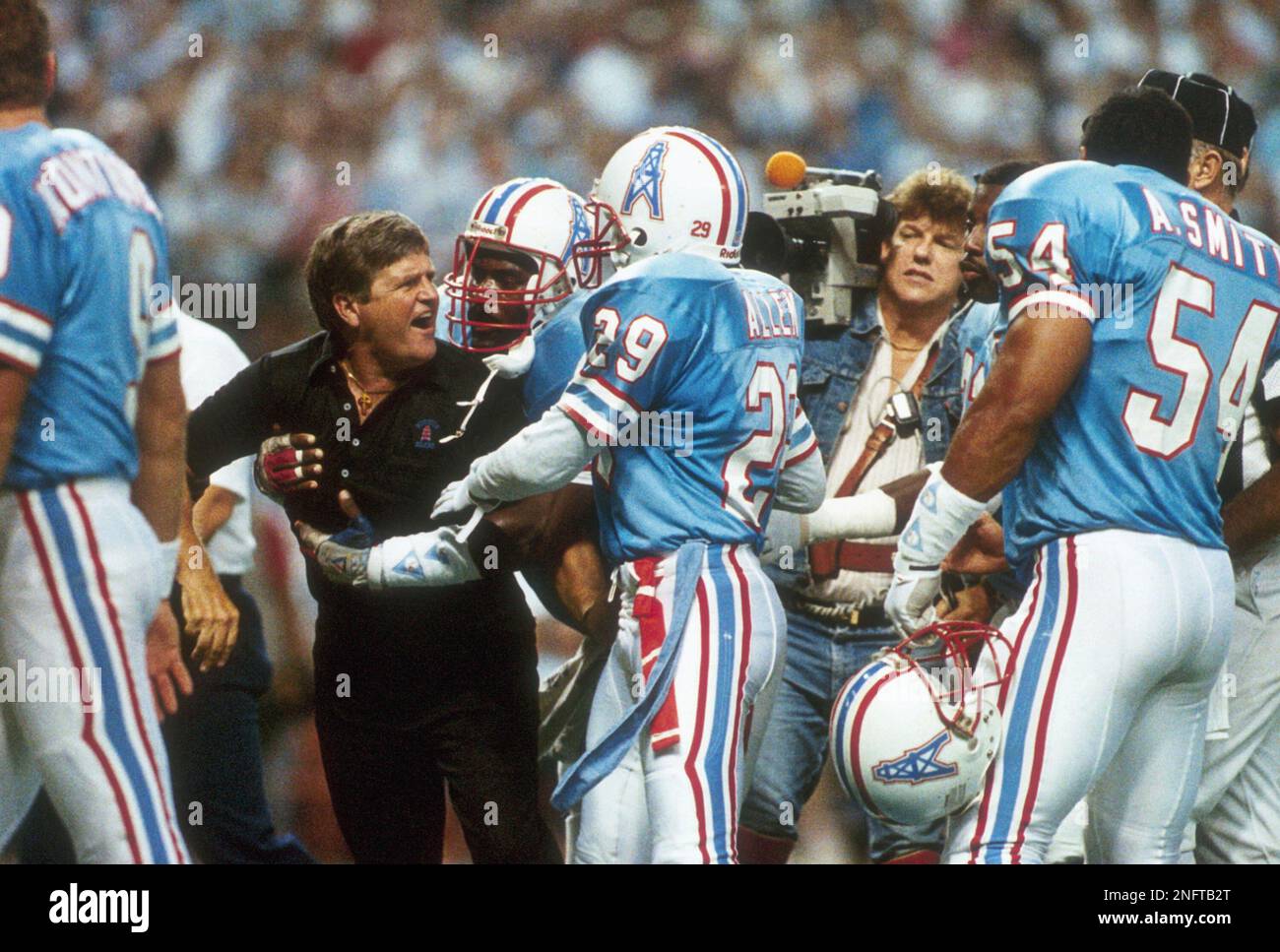 Houston Oilers coach Jerry Glanville as he restrained by his players as