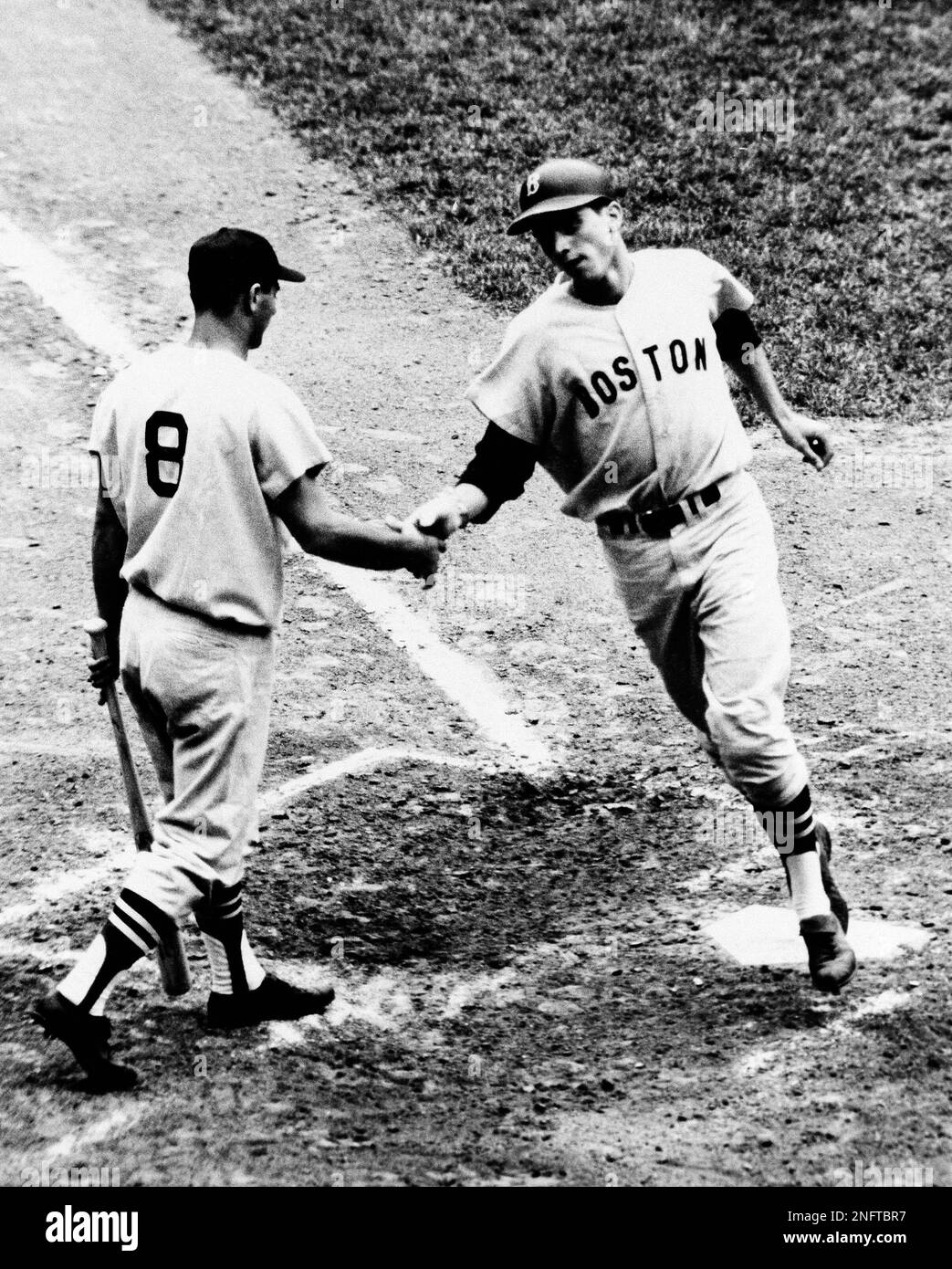 Tony Conigliaro Boston Red Sox Center fielder is greeted at home plate by  teammate Russ Nixon after hitting a tremendous home run over the left field  wall, screen and adjoining street his