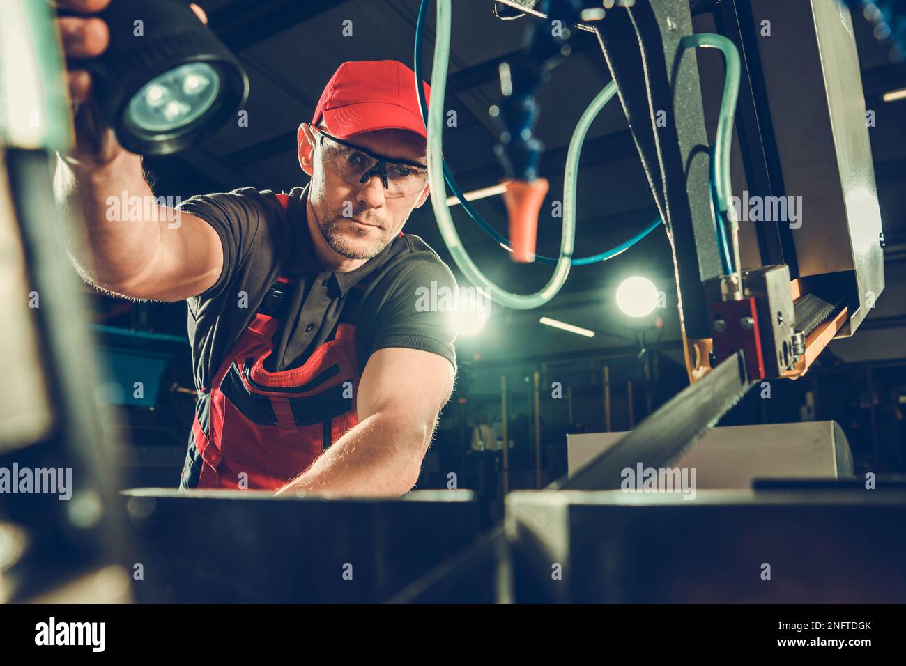 Professional Band Saw Operator Supervising the Cutting Process During