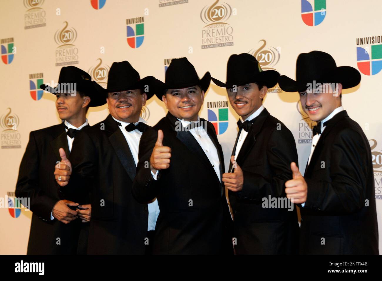 Los Alegres de la Sierra of Mexico pose on the red carpet for the