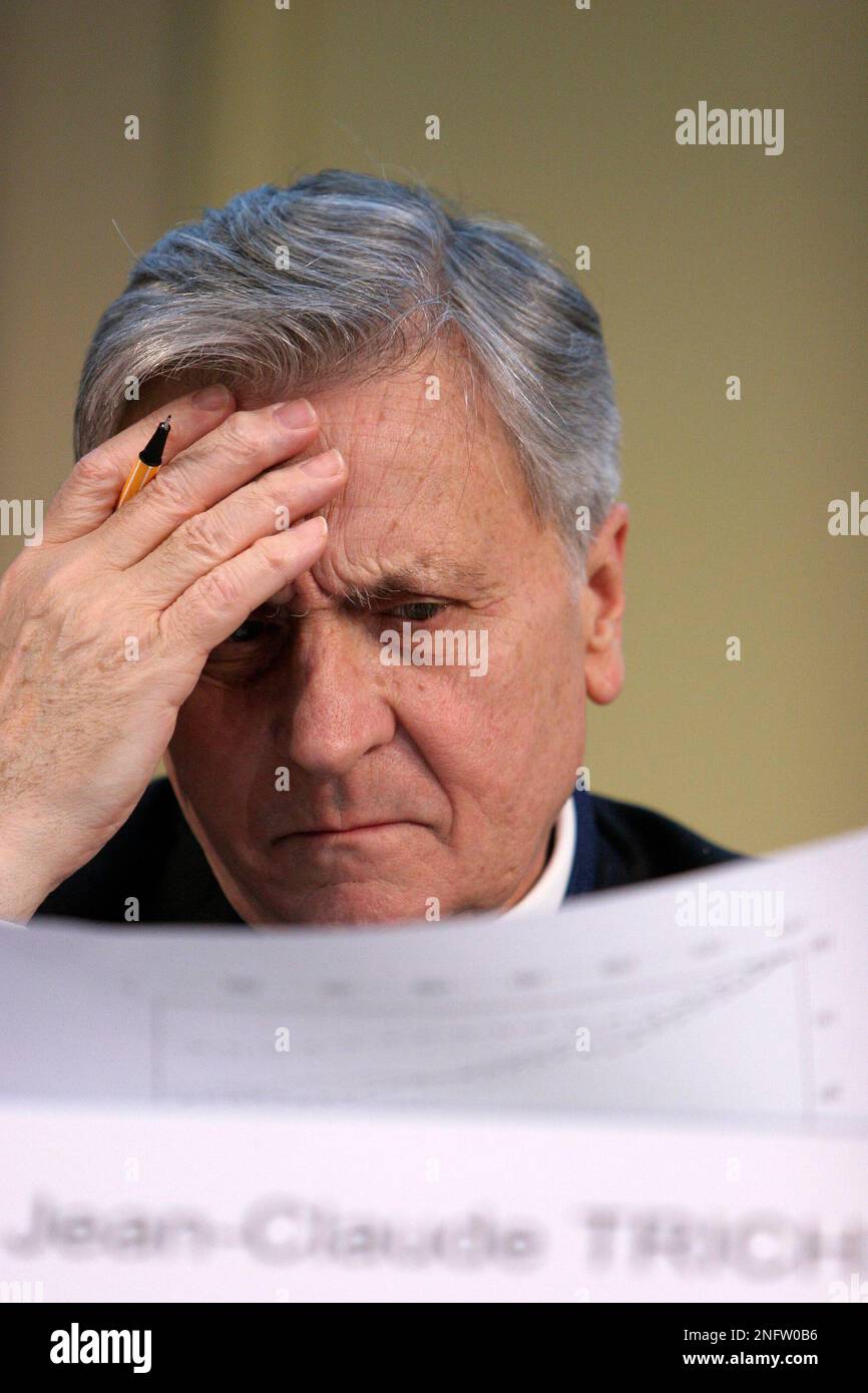 Jean-Claude Trichet, President of the European Central Bank, looks at his  papers during the International Symposium of the Banque de France, Friday,  March 7, 2008 in Paris. The theme of the conference