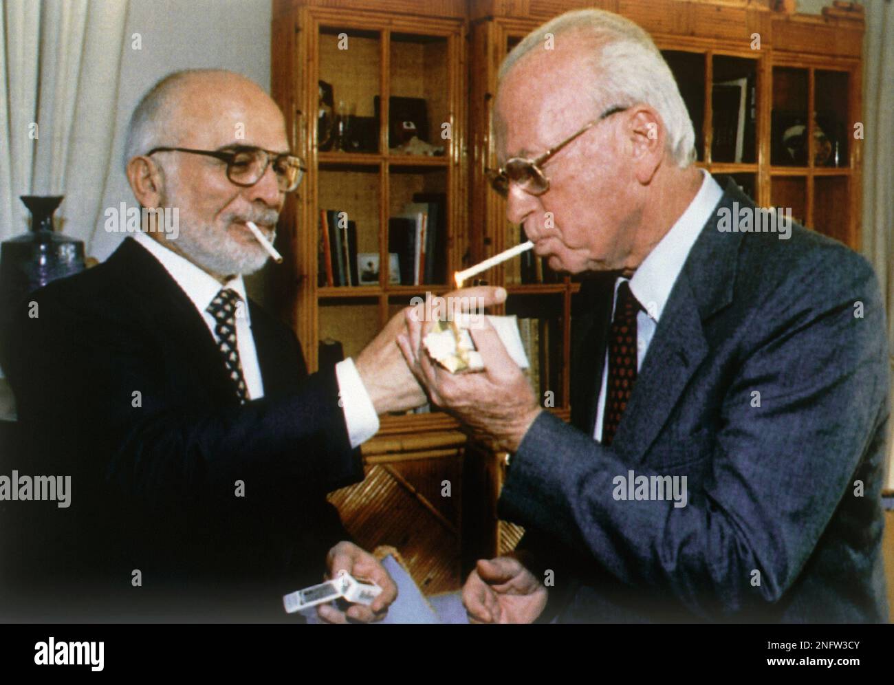 King Hussein of Jordan, left, holds light for Israeli Prime Minister ...