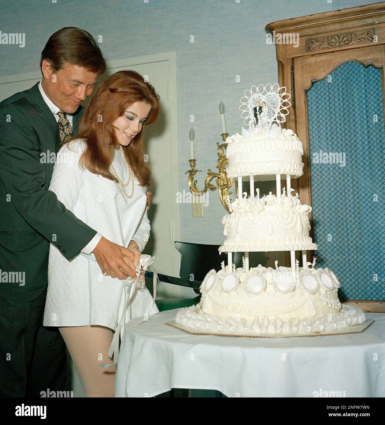 Actors Ann-Margret and Roger Smith are shown cutting the cake on their ...