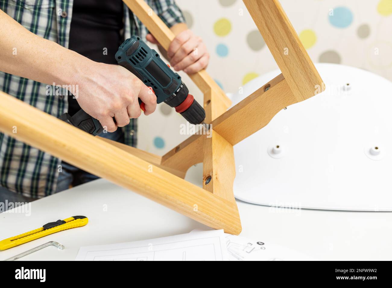 Assemble furniture. Man assembling chair. Furniture assembler with