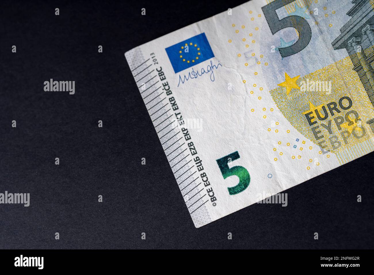 5 euro close up on black background for business finance subjects. World money concept, inflation and economy concept. Currency close up in detail. Stock Photo