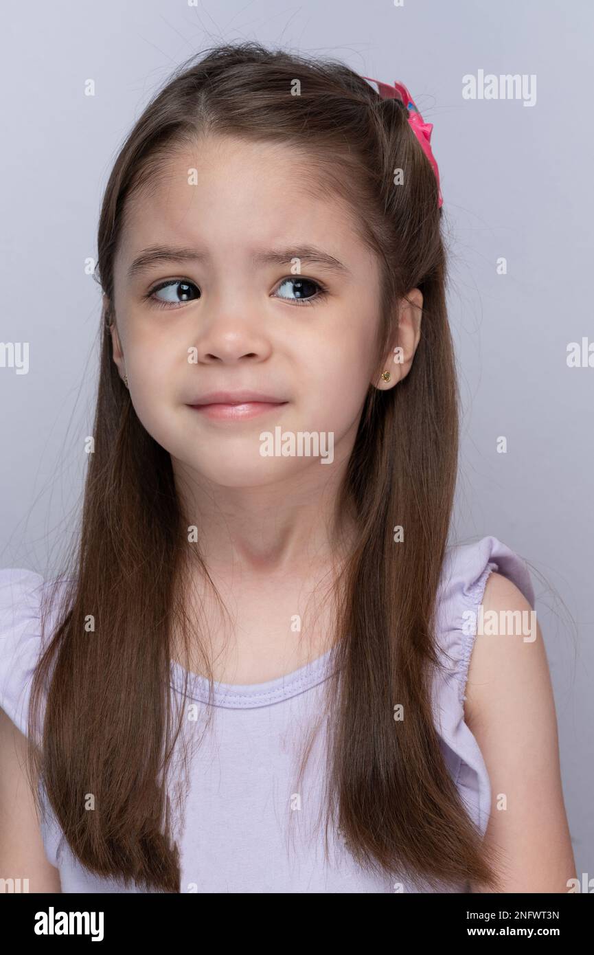 Sad kid girl look on side portrait headshot close up view Stock Photo