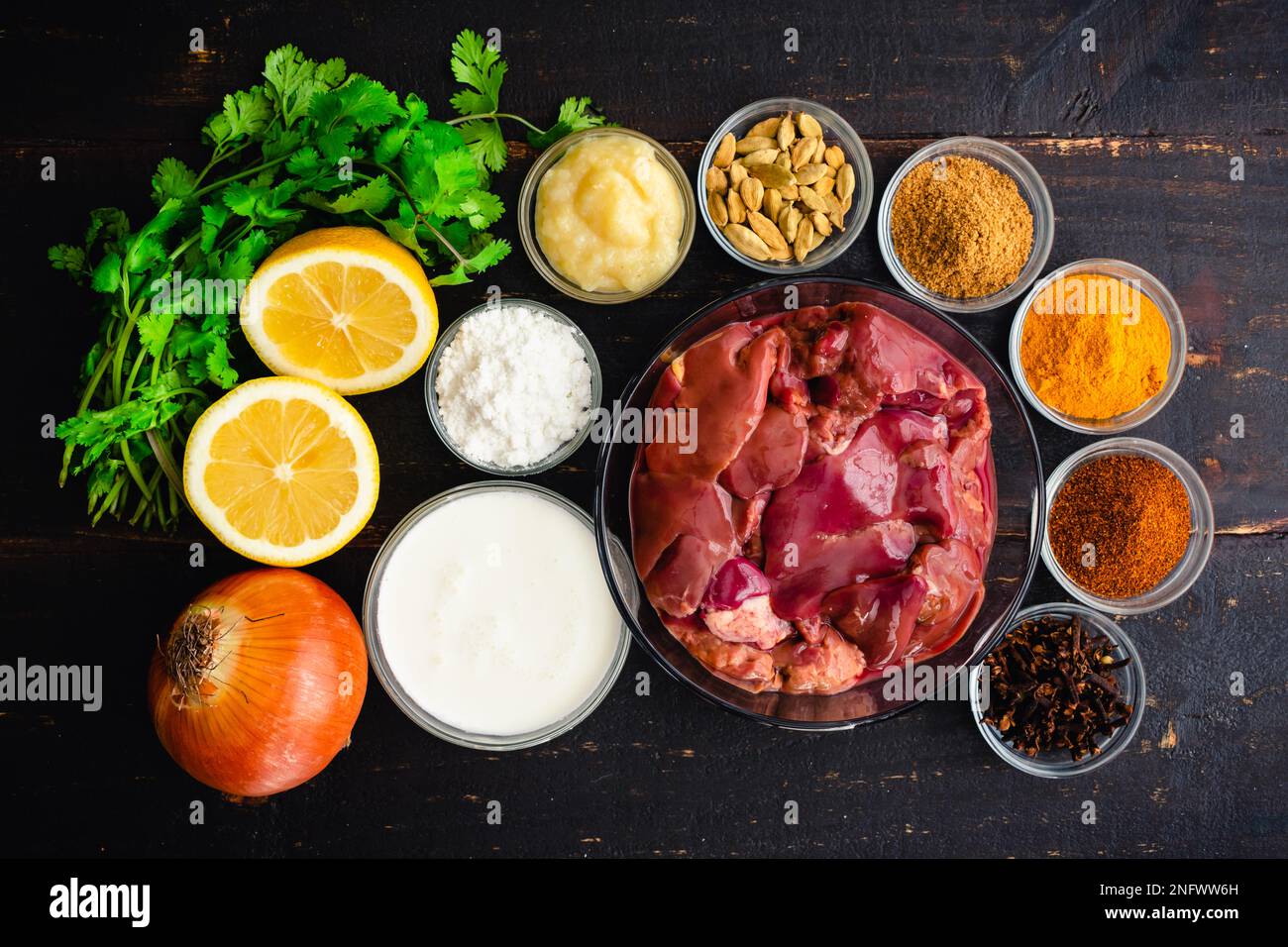 Chicken Liver Curry Ingredients on a Dark Wood Background Raw chicken