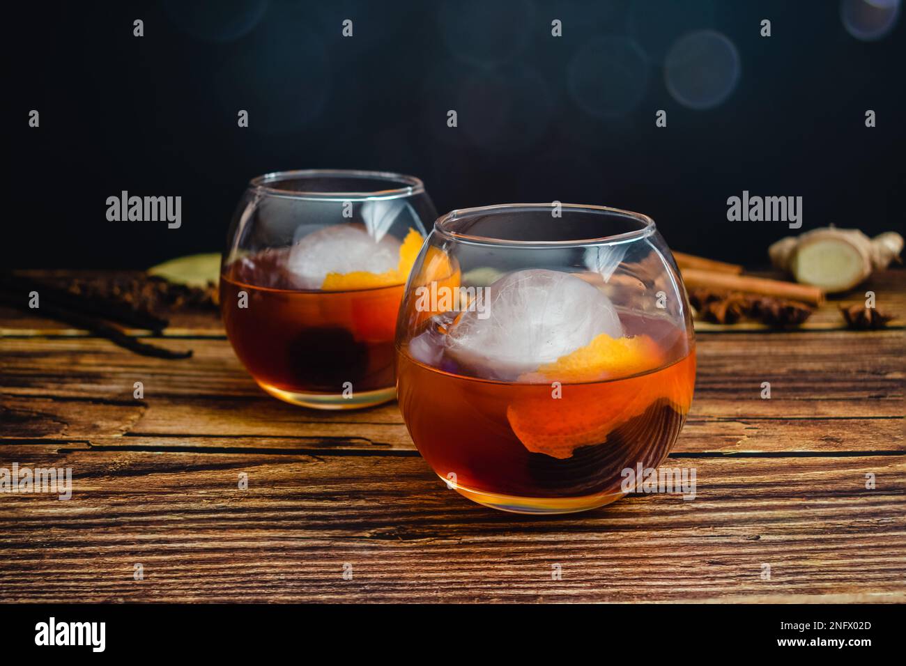 Spiced Old Fashioned Cocktail in a Balloon Glass With an Ice Sphere