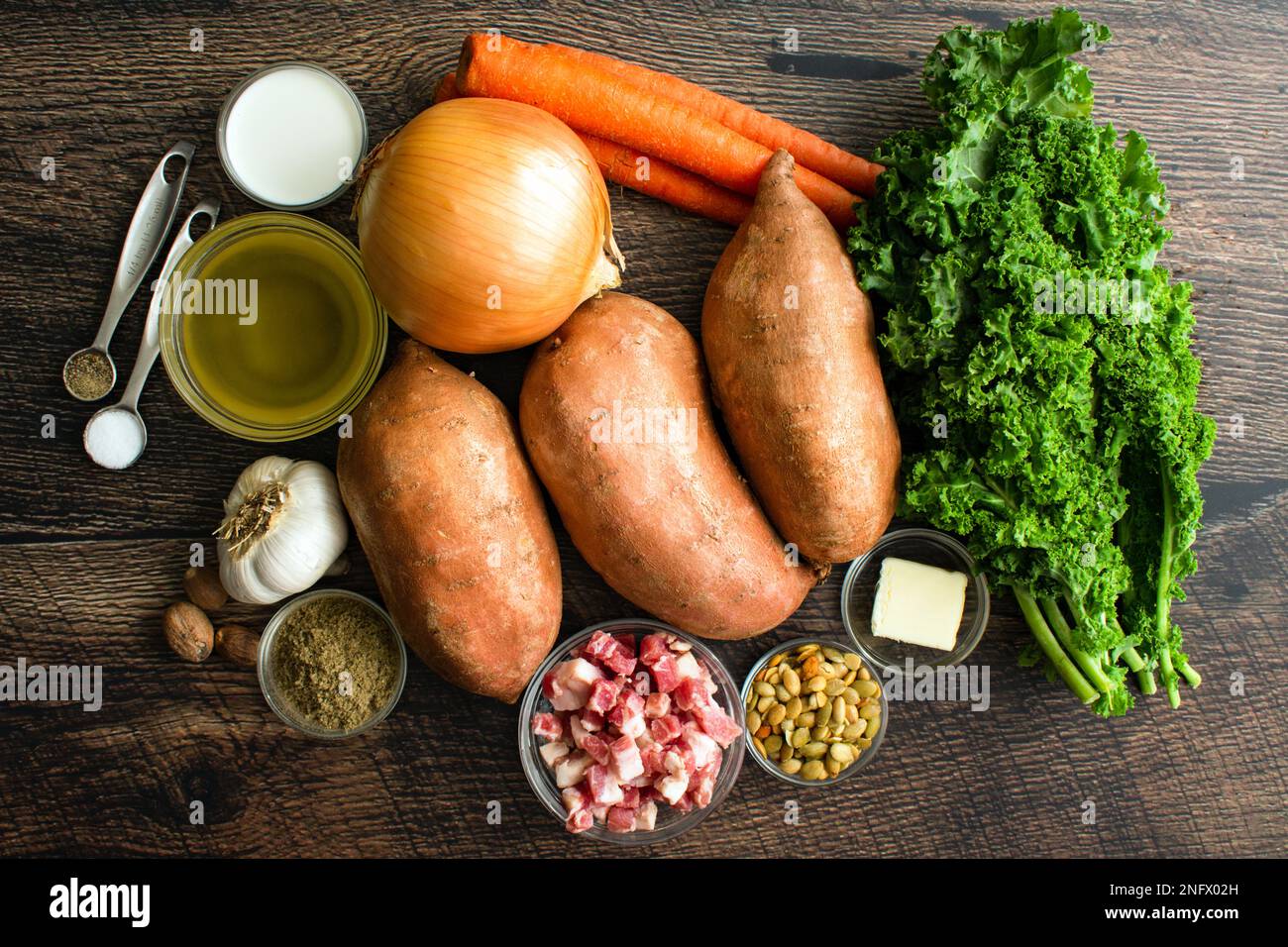 Sweet Potato Chowder Ingredients on a Wood Table: Raw sweet potatoes ...