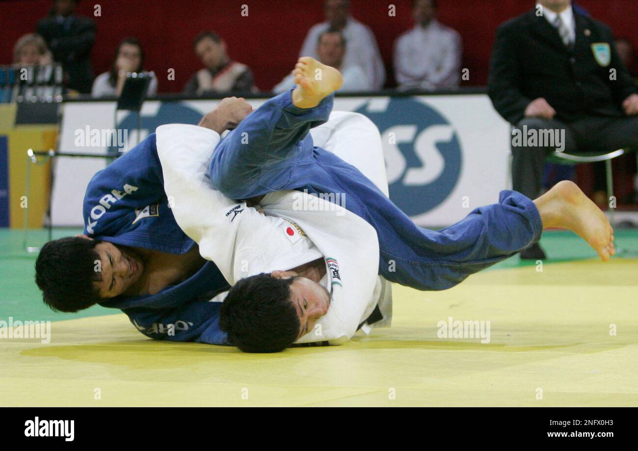 Japan's Hiraoki Hiraoka, in white, fights to win the Men's 60kg Judo
