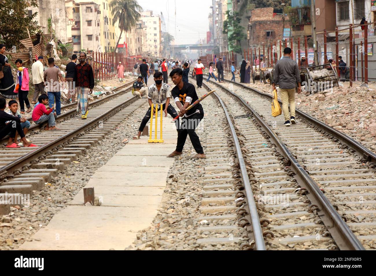 Dhaka, Bangladesh. 17th Feb, 2023. Due to lack of adequate playground in Dhaka, boys are playing cricket between two railway lines. (Credit Image: © Syed Mahabubul Kader/ZUMA Press Wire) EDITORIAL USAGE ONLY! Not for Commercial USAGE! Credit: ZUMA Press, Inc./Alamy Live News Stock Photo