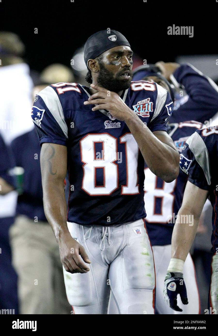New England Patriots receiver Randy Moss (81) looks on from the sidelines  in the fourth quarter during the Super Bowl XLII football game against the  New York Giants at University of Phoenix