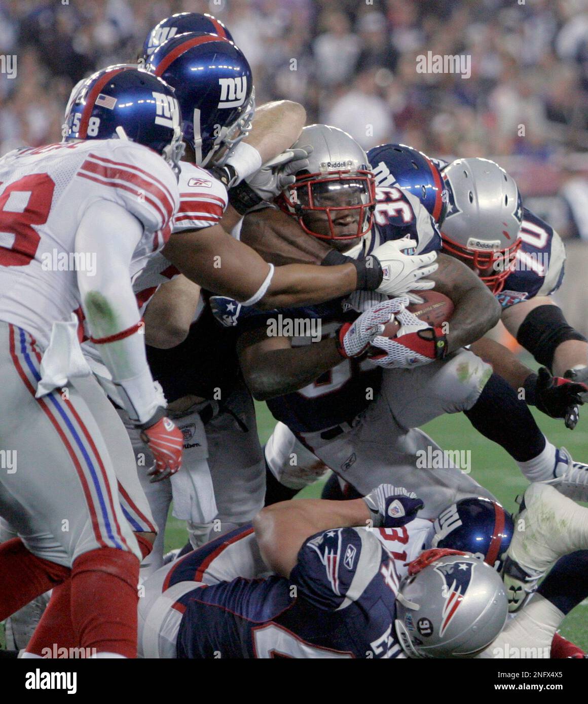 New England Patriots running back Kevin Faulk 33 is stopped short of the goal line by a host of New York Giants during the second quarter of the Super Bowl XLII football
