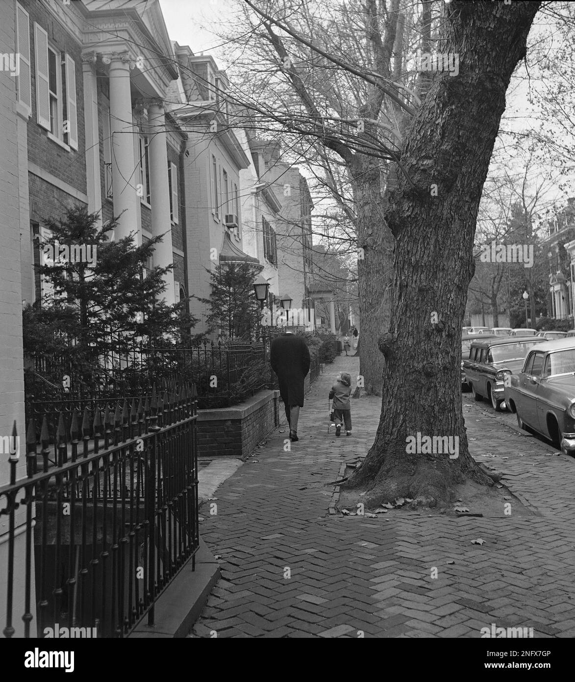 Presidentelect John F. Kennedy looks down at his 3yearold daughter