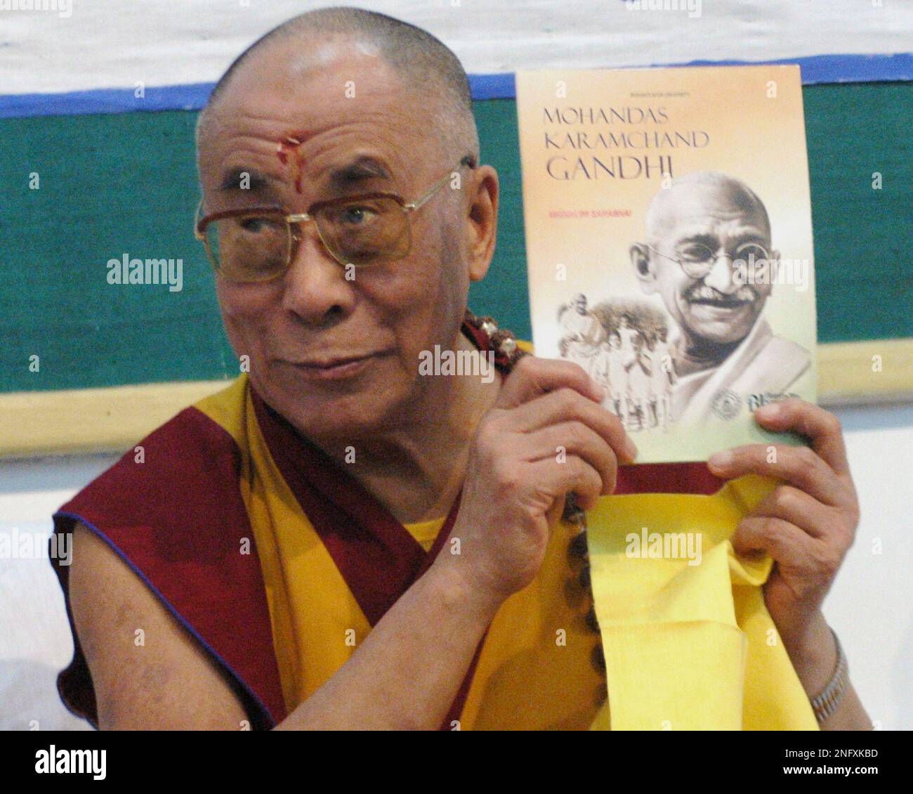 Tibetan spiritual leader Dalai Lama holds a book on Mahatma Gandhi after  unveiling it at Gujarat Vidhyapith during his lecture on 'world peace' in  Ahmadabad, India, Saturday, Jan. 19, 2008. Dalai Lama