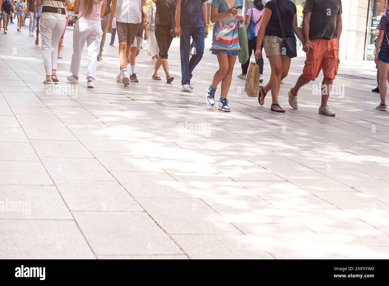 The pedestrians walking along the leisure street Stock Photo