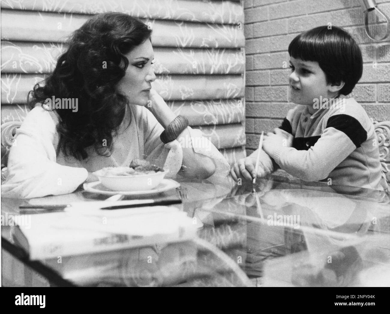 US American pop singer Connie Francis sits at a glass table with her ...