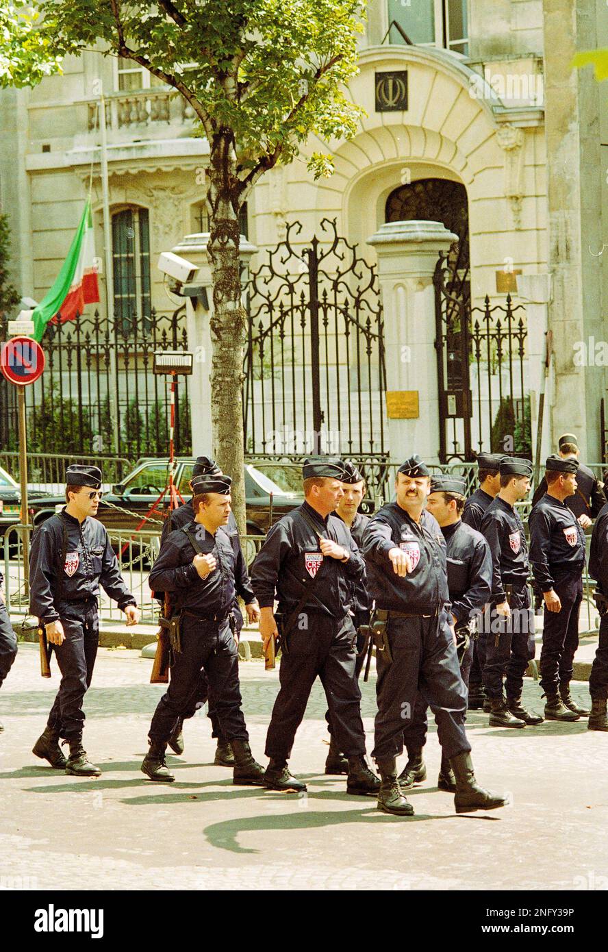 French riot police holding rifles pass in front of the Paris Iranian ...