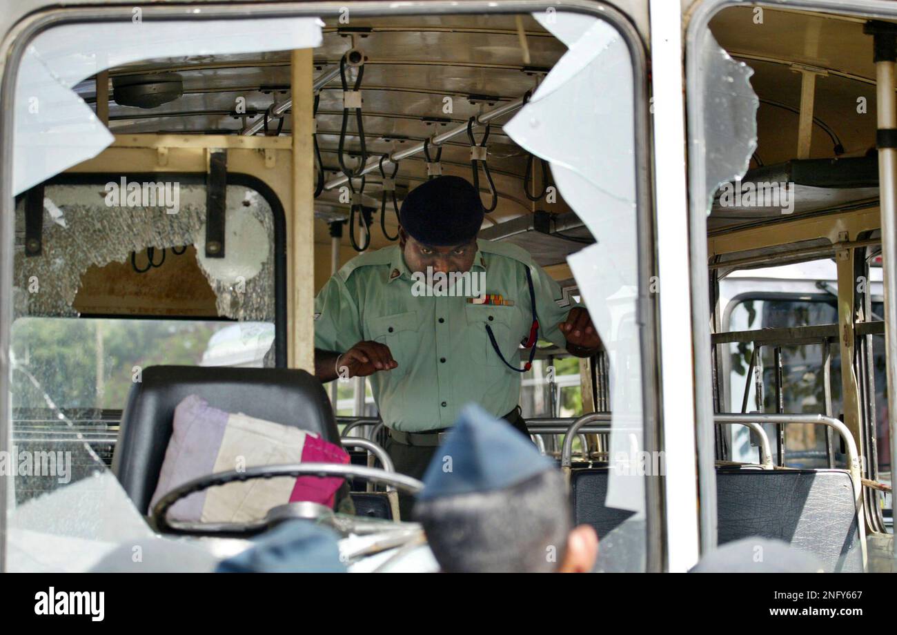 A Sri Lankan army soldier checks inside of the exploded bus at after a ...