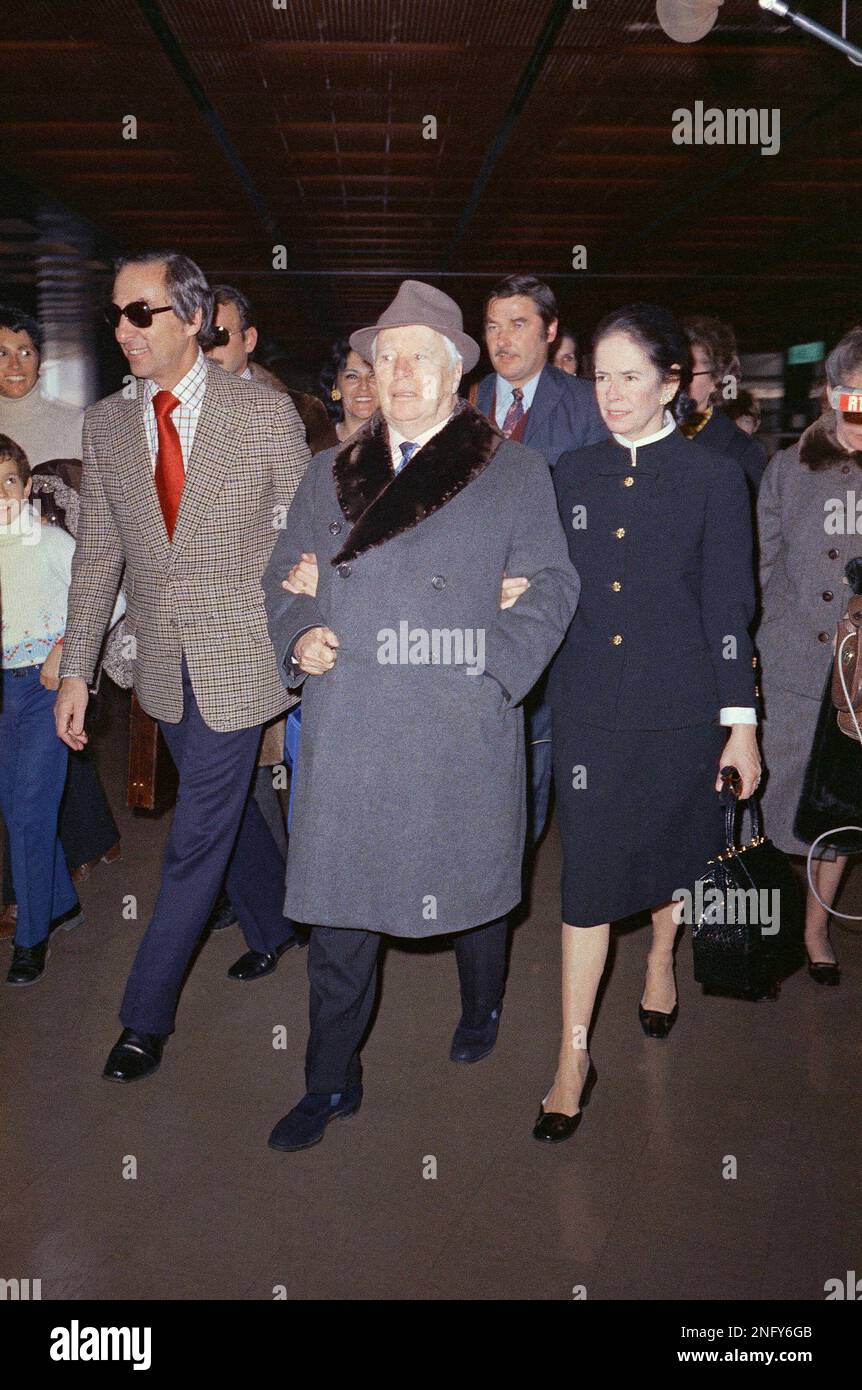 Charlie Chaplin, center, arriving at Orly Airport in Paris with his ...