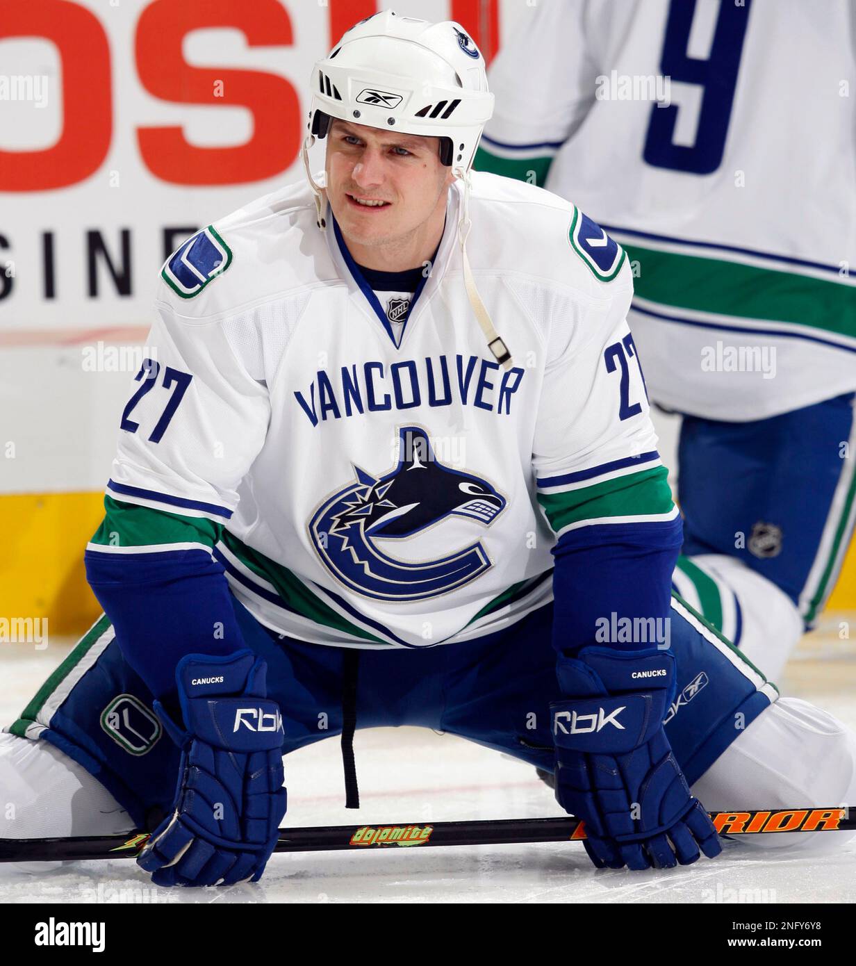 Vancouver Canucks left winger Brad Isbister stretches before playing