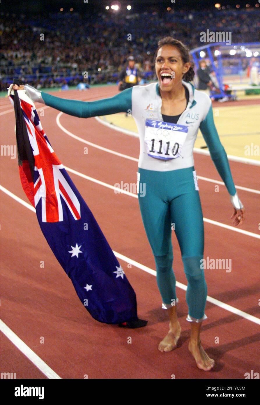 Australia's Cathy Freeman celebrates after winning the gold medal in the 400-meter race at the Summer Olympics, Monday, Sept. 25, 2000, at Olympic Stadium in Sydney. (AP Photo/Michael Probst) Stock Photo