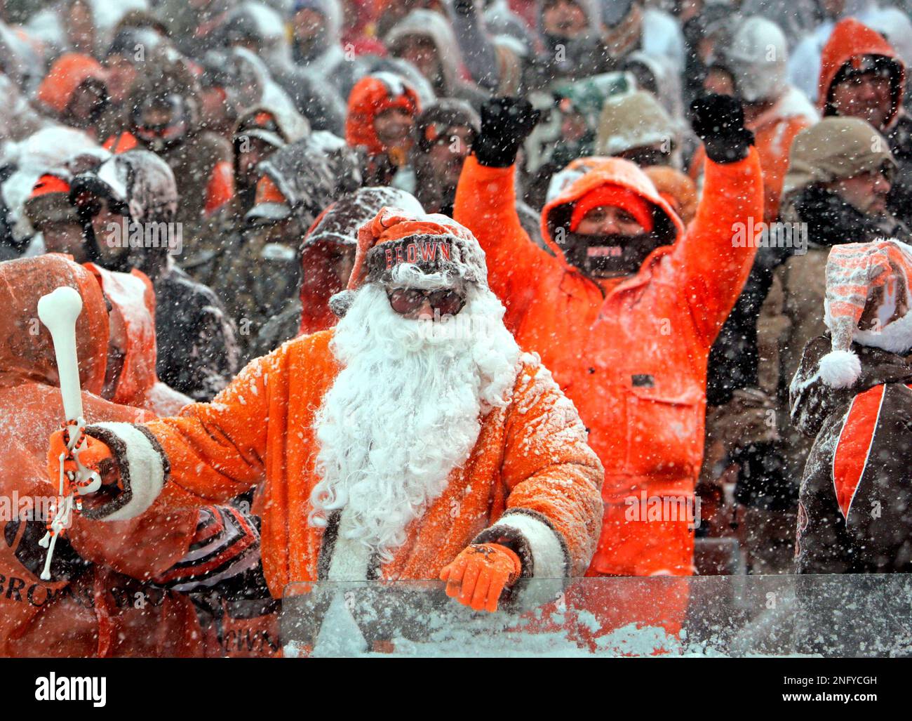 Cleveland Browns fans cheer in the snow during an NFL football