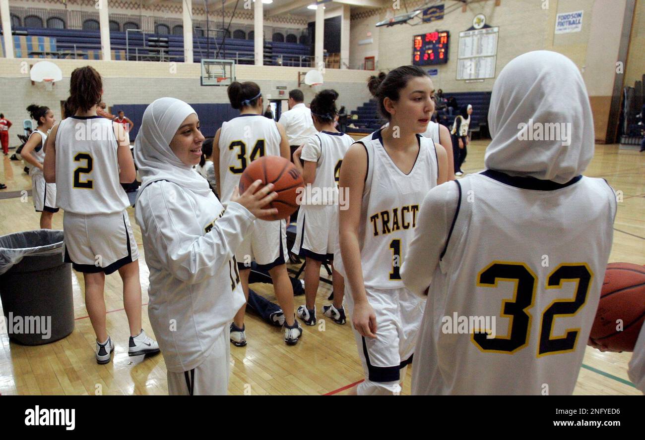 Fordson High School basketball player Fatima Kobeissi, left and teammate  Hyatt Bakri (32) wait before the basketball game against Willow Run in  Dearborn, Mich., Tuesday, Dec. 4, 2007. As more covered Muslim