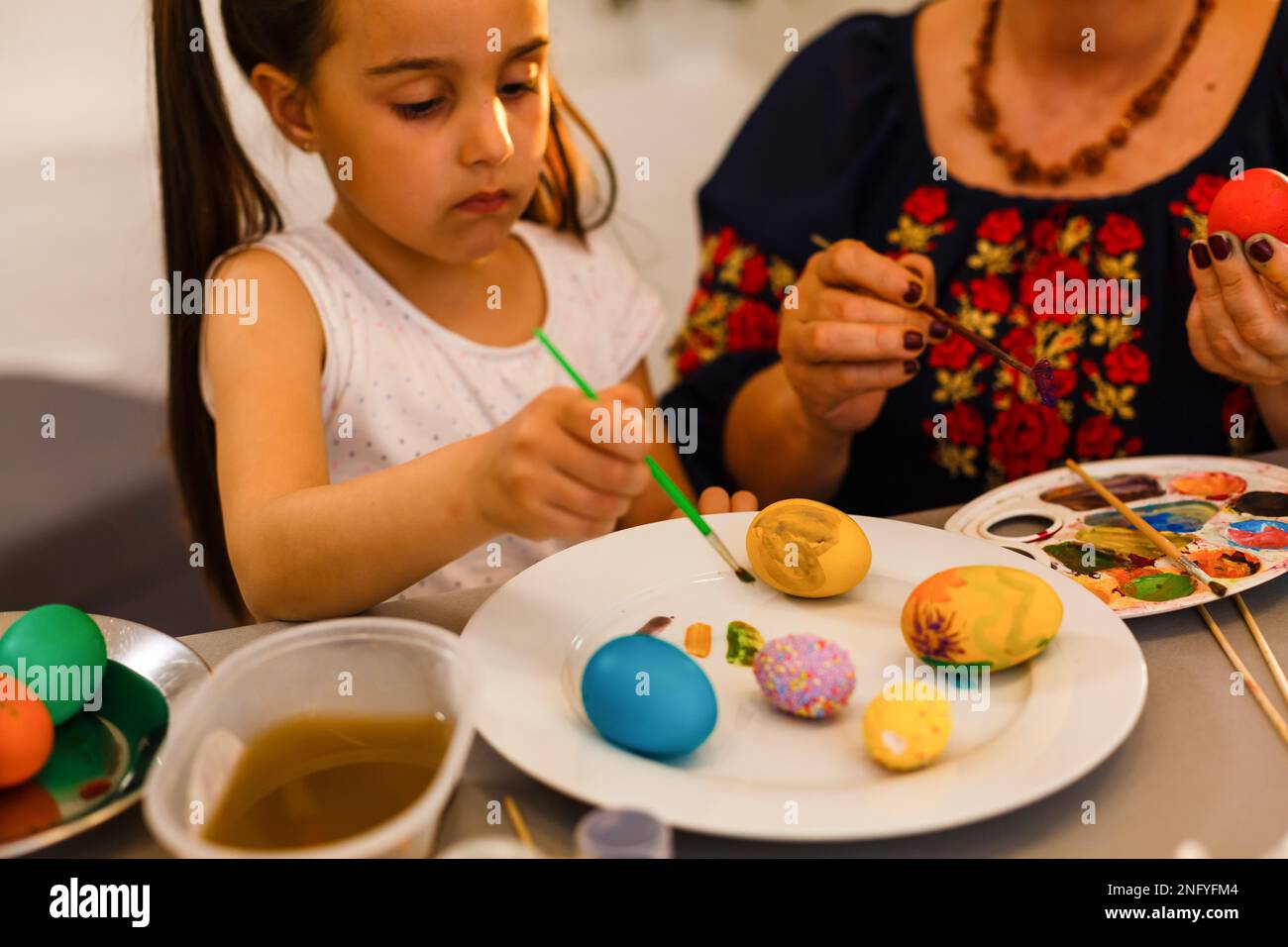 colouring eggs for eastertime at home Stock Photo