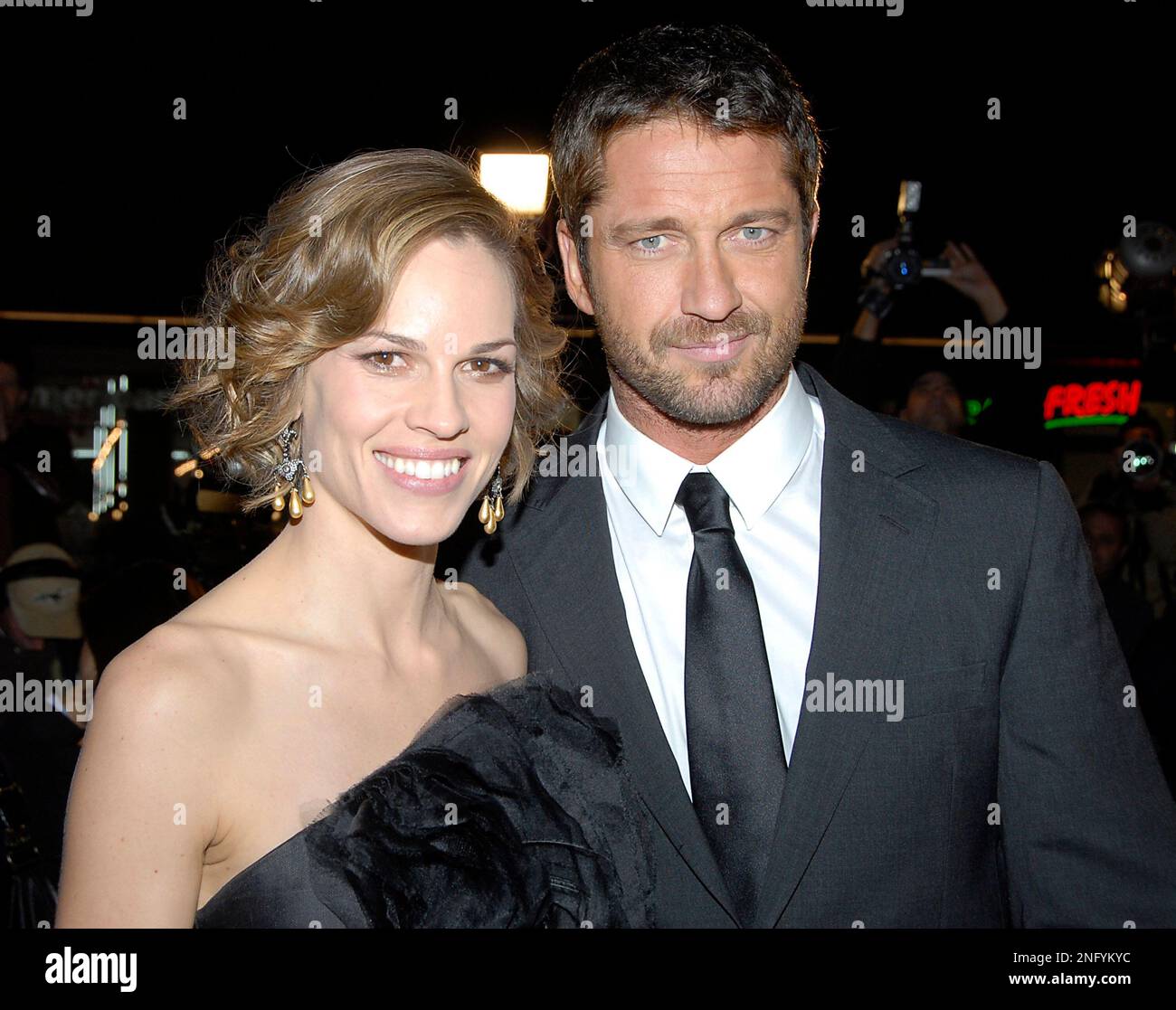 Actress Hilary Swank, left, and actor Gerard Butler, right, pose on the