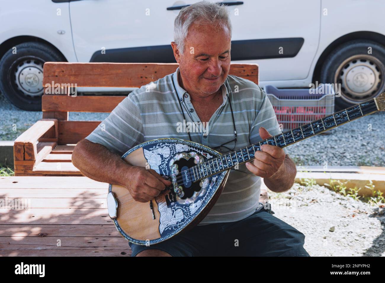 Mr Costas Violaris, owner of Agrovino Farm plays on a bouzouki in