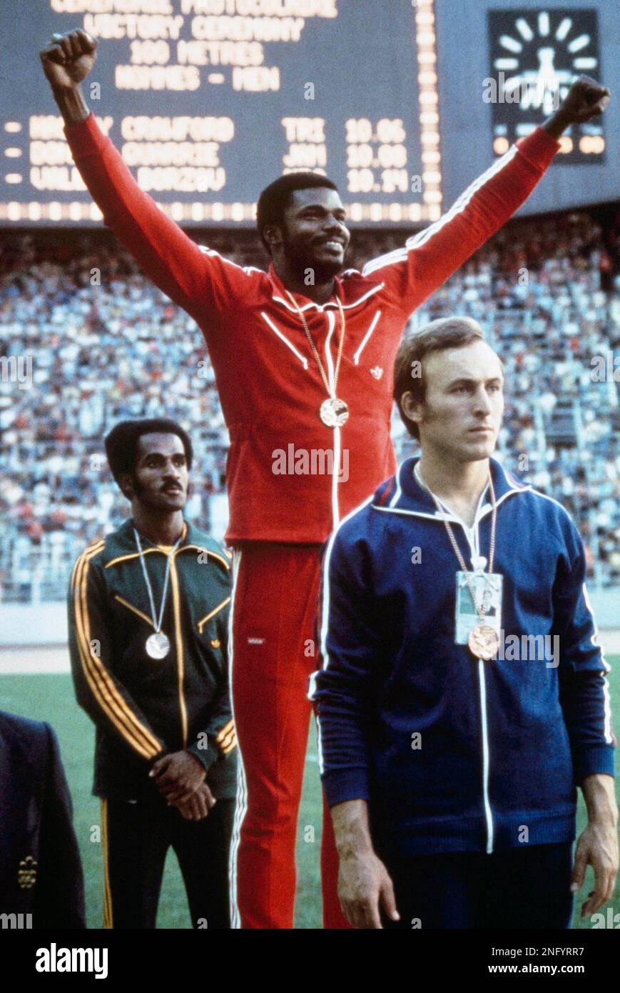 Front to back: Valerij Borzov, USSR, bronze medal; Hasely crawford, arms  upraised, Trinidad, gold medal and