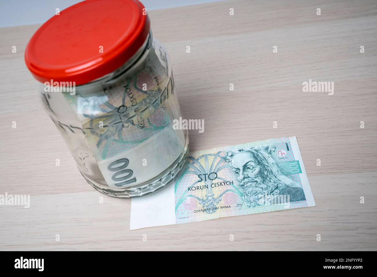 100 korun banknote of the Czech Republic banknotes in the glass jar