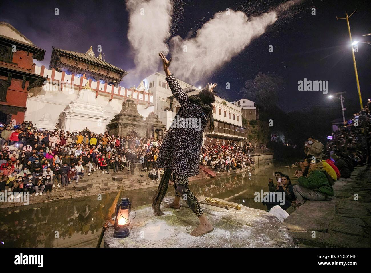 Kathmandu, Nepal. 17th Feb, 2023. A Hindu holy man, or Sadhu, the follower of Lord Shiva, throws ashes as he performs Tandava, a divine dance performed by Deity Shiva, a source of creation, dissolution, and preservation on the eve of the Maha Shivaratri festival at the premises of Pashupatinath Temple in Kathmandu. Hindu Devotees from Nepal and India come to this temple to take part in the Shivaratri festival which is one of the biggest Hindu festivals dedicated to Lord Shiva and celebrated by devotees all over the world. Credit: SOPA Images Limited/Alamy Live News Stock Photo