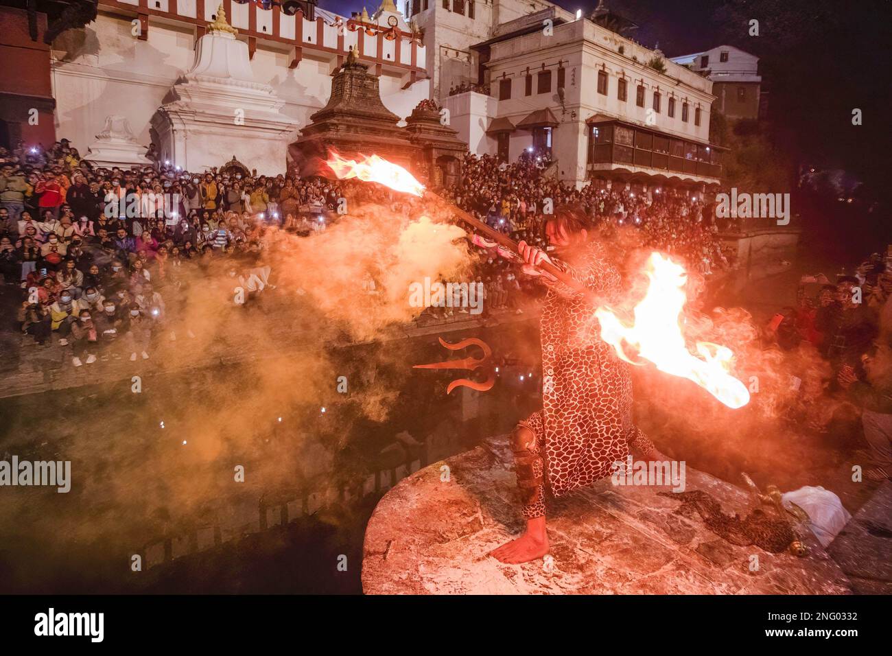 A Hindu holy man, or Sadhu, the follower of Lord Shiva, throws ashes as he performs Tandava, a divine dance performed by Deity Shiva, a source of creation, dissolution, and preservation on the eve of the Maha Shivaratri festival at the premises of Pashupatinath Temple in Kathmandu. Hindu Devotees from Nepal and India come to this temple to take part in the Shivaratri festival which is one of the biggest Hindu festivals dedicated to Lord Shiva and celebrated by devotees all over the world. (Photo by Prabin Ranabhat/SOPA Images/Sipa USA) Stock Photo
