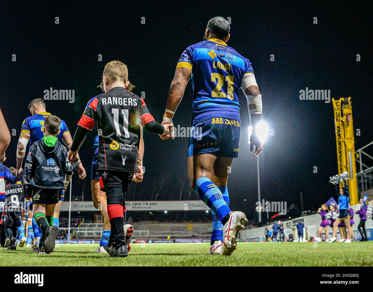 Wakefield, UK. 17th Feb, 2023. Samisoni Langi of Wakefield Trinity, walking out with a young player  Wakefield Trinity v Catalan Dragons,  at the Bell vue, Wakefield, West Yorkshire, UK on the 17th February 2023  Photo Credit Craig Cresswell Photography Credit: Craig Cresswell/Alamy Live News Stock Photo