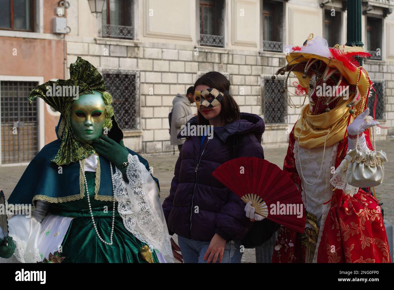 Venice, Italy. 17 Feb 2023. Three masked women pose for pictures at Campo San Geremia during Carnevale di Venezia. Credit: Philip Yabut/Alamy Live News Stock Photo