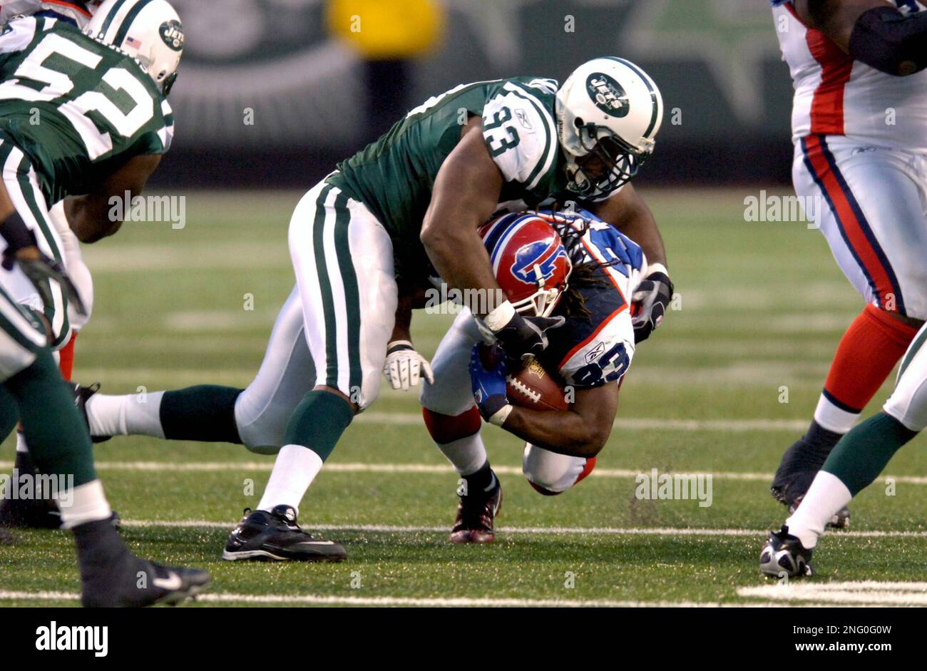 New York Jets Kenyon Coleman dives for Miami Dolphins Ronnie Brown