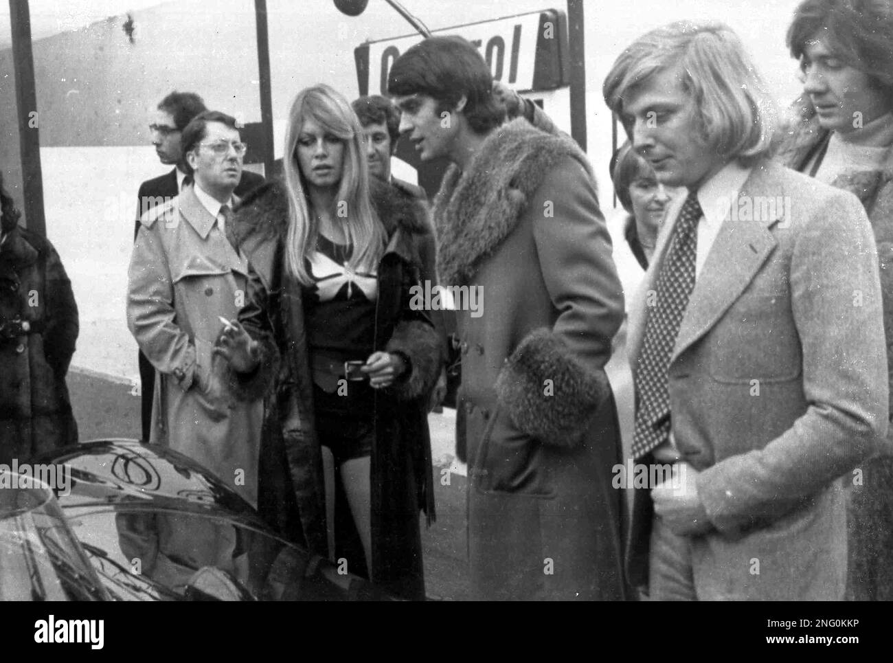 French film actress Brigitte Bardot talks with French racing driver Francois Cevert, at the Racing Car Show, in Paris, France, Feb. 12, 1971. (AP Photo/Marqueton) Stock Photo
