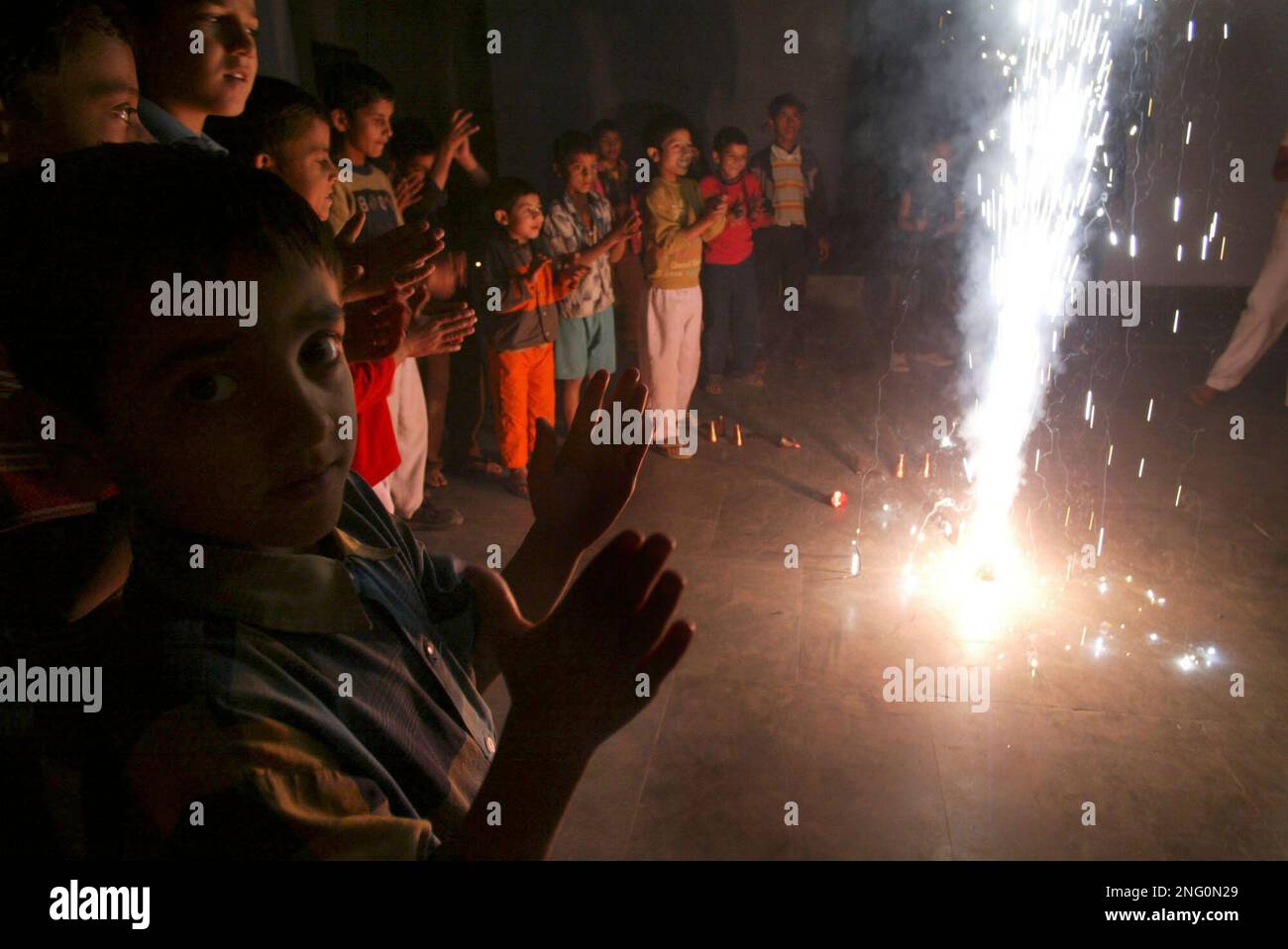 Children light fire crackers to celebrate Chinese New Year China