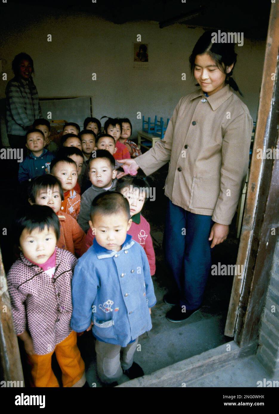 Chinese children pose with teacher outside a school in Beijing, 1980 ...