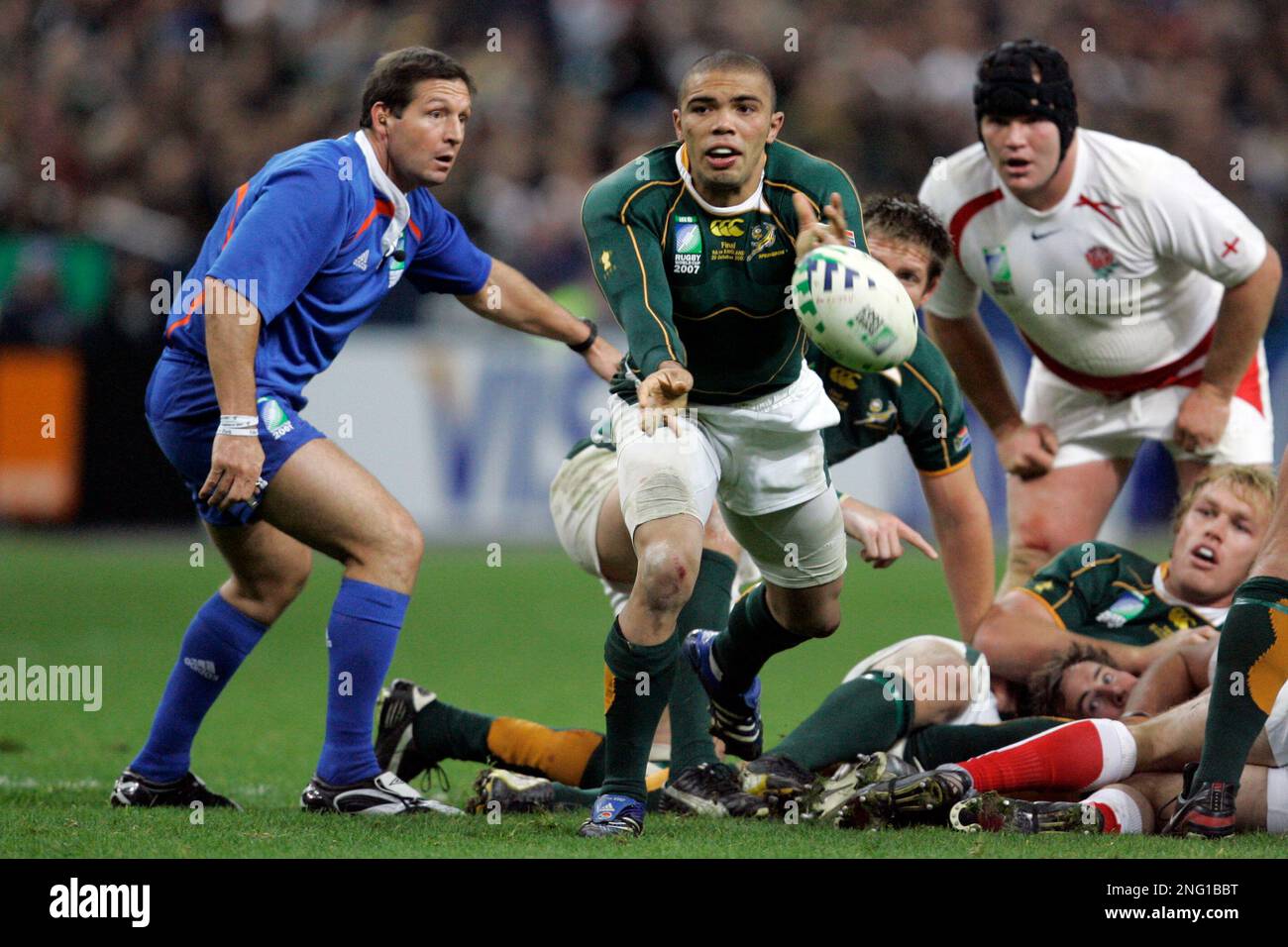 South Africa's Bryan Habana passes the ball as referee Alain Rolland of  Ireland, left, looks on, during the Rugby World Cup final against England,  Saturday, Oct. 20, 2007 at the Stade de