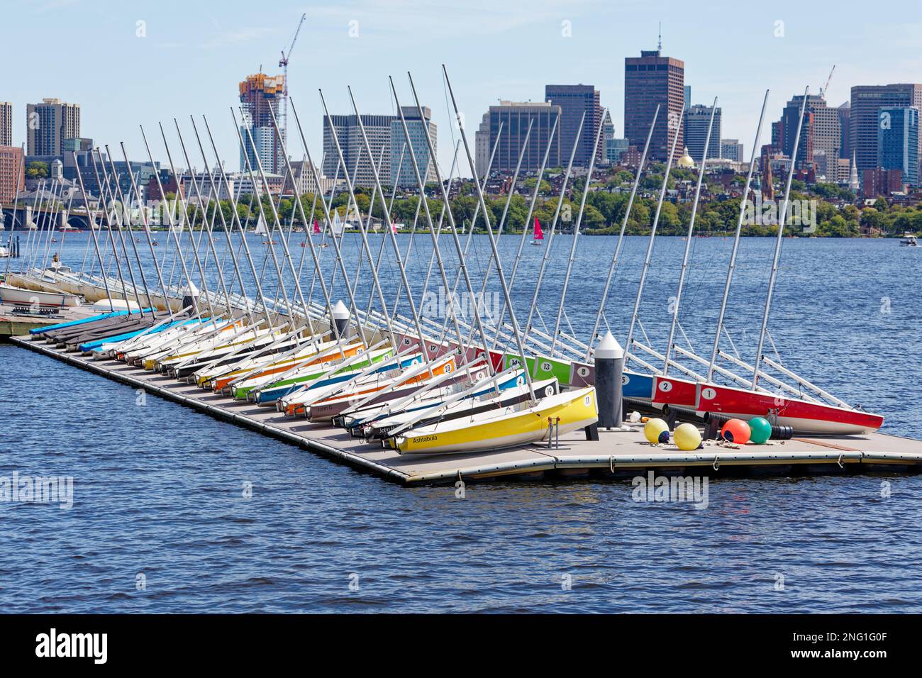 Charles River: MIT Sailing Pavilion boats, viewed from the Dr. Paul Dudley White Bike Path. Longfellow Bridge and Beacon Hill are in the background. Stock Photo
