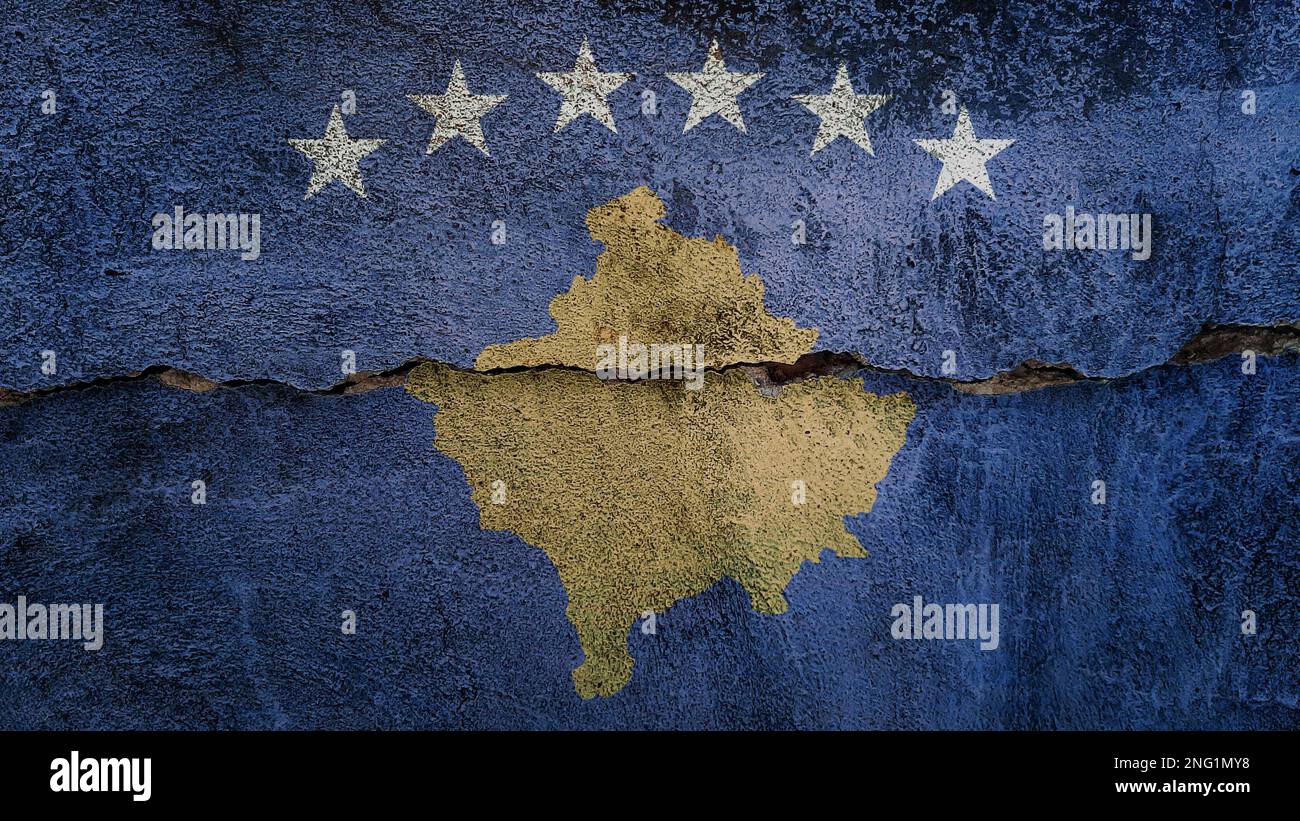 Kosovo flag on cracked wall. Earthquake or drought concept Stock Photo