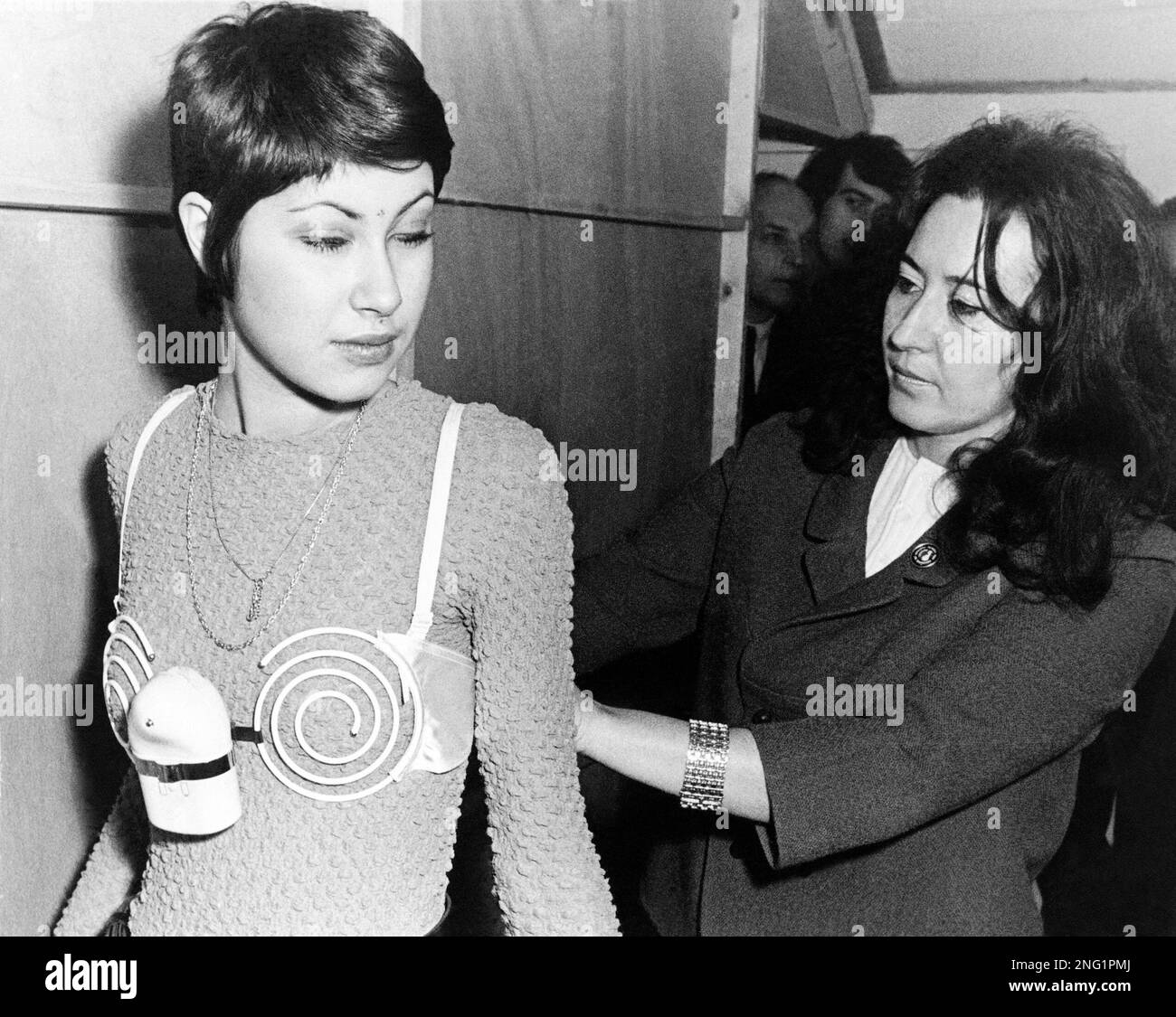 A model sports a spiral electric bra, invented by the Belgian, Malrait at  the 20th International Show of Inventions in Brussels, Belgium, March 13,  1971. The bra is claimed to develop and
