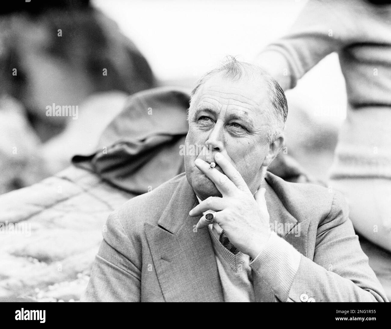 U.S. President Franklin D. Roosevelt smokes a cigarette as he sits on the  rocks at Herring Cove on Campobello Island, New Brunswick, Canada on July  30, 1936. President Roosevelt and family have