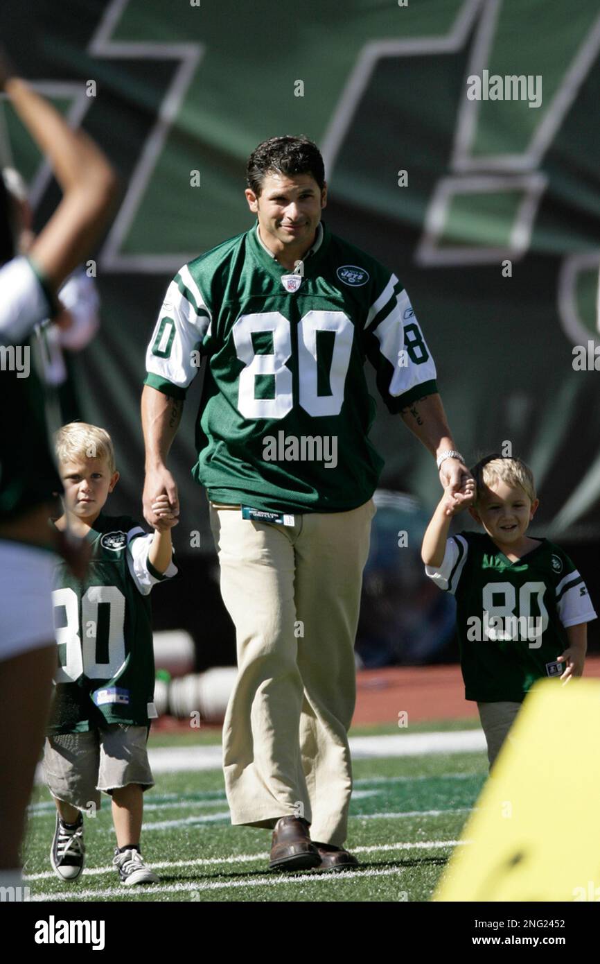 Former New York Jet Wayne Chrebet walks onto the field with his two ...