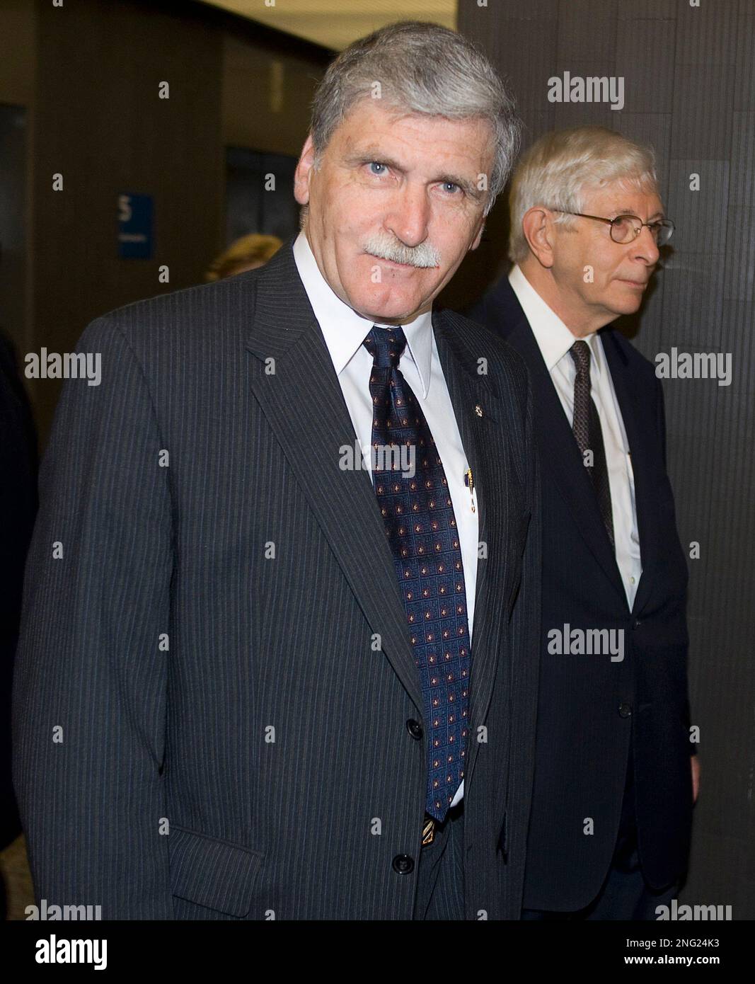Retired general Romeo Dallaire, left, arrives at court with his 